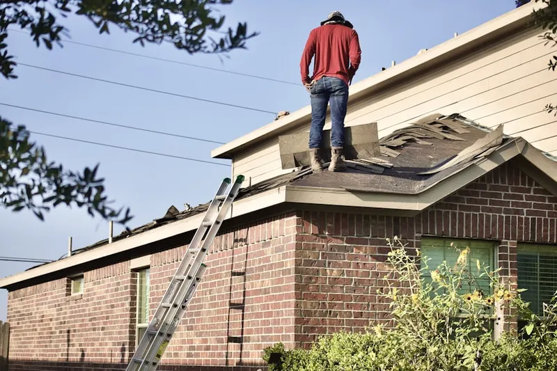 Professional roofer working on a residential roof in Paradise Falls